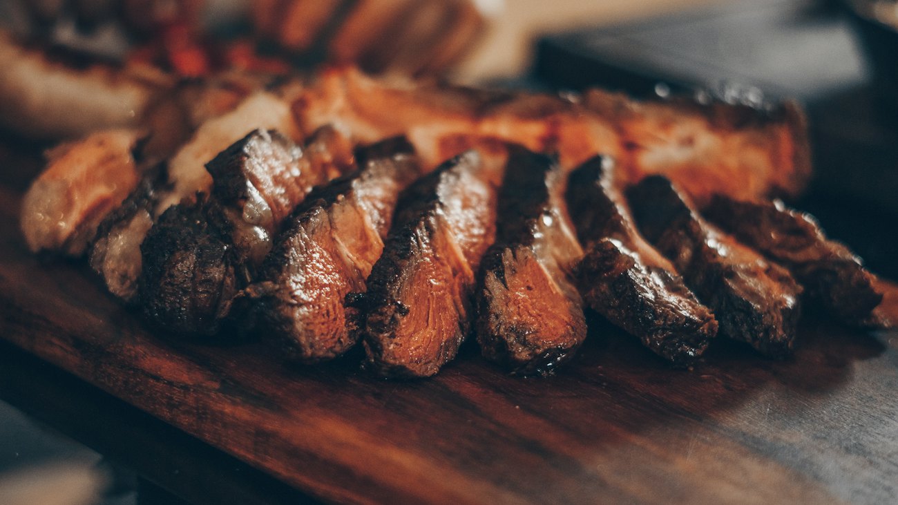 Wood-fired beef, sliced on a walnut board