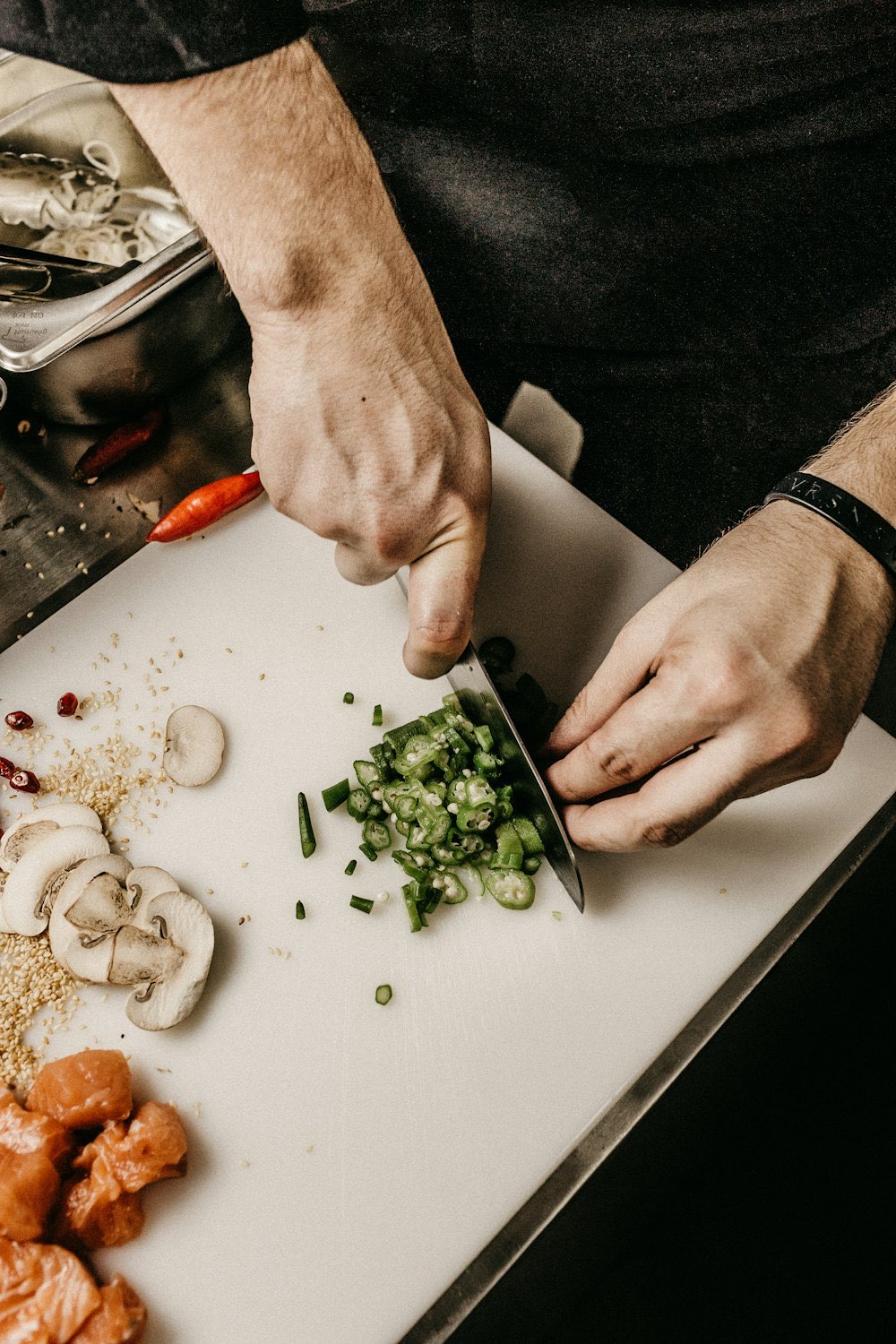 A cook chopping fresh herbs in the Marrow and Sage kitchen